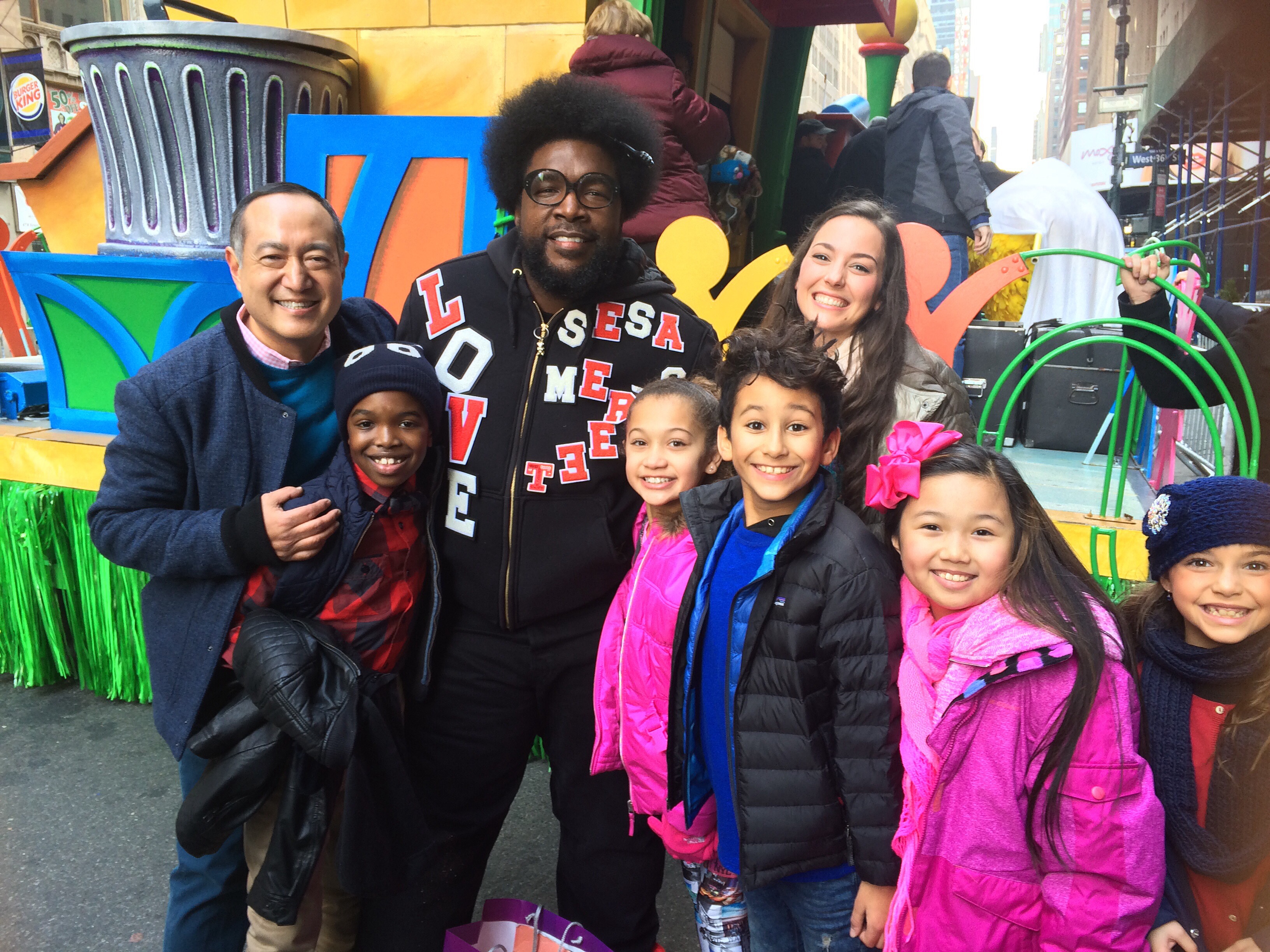 Alan Muraoka, Questlove, Suki Lopez, fellow child performers & RAINA CHENG pose for pics before boarding on the Sesame Street Float at the 89th Macy's Thanksgiving Day Parade, 11/26/2015