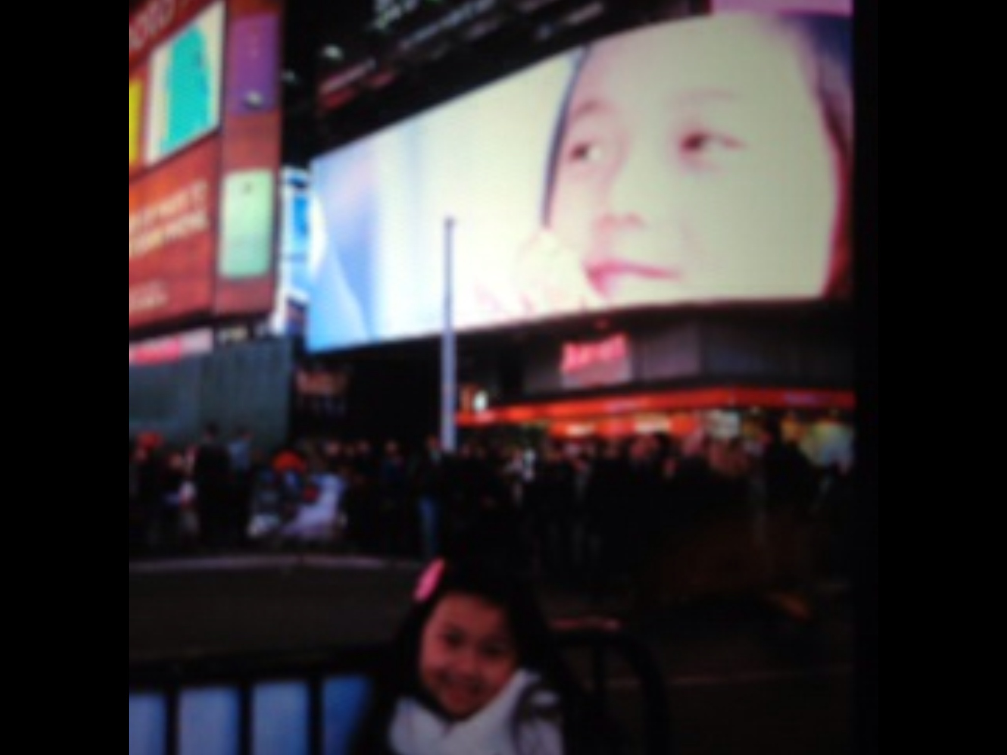 Raina Cheng in front of her Bank of America Commercial on a Times Square Jumbotron TV. 2013