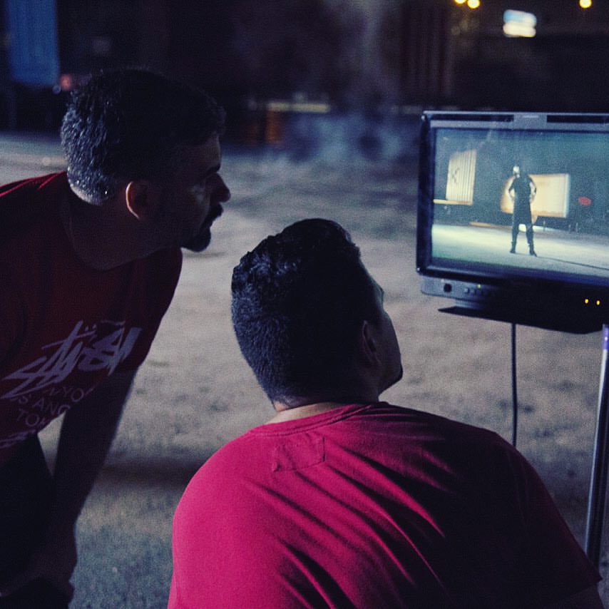Director Jose Sagaro looking at the details in the shot before rolling. 2015