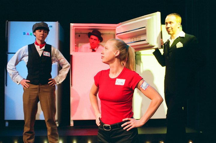 Kellie Waymire, Tom Elliott, Rebecca Avery and Kevin Fabian in a photo still from: An American Book Of The Dead, The Game Show by Paul Mullin for Circle X Theatre Company.