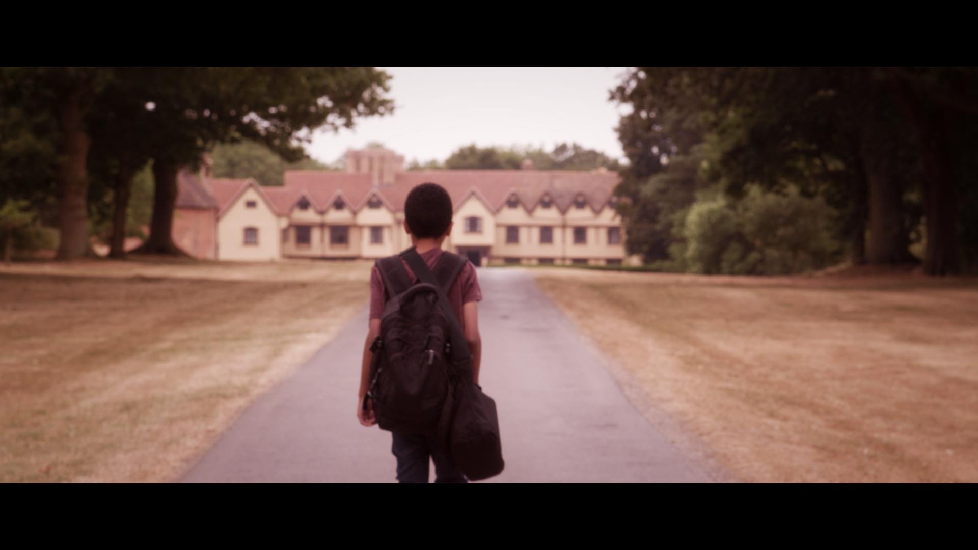 Young Cosmo (Sam Wilson) walks towards the orphanage in Callum Andrew Johnston's, The Forbidden Note.