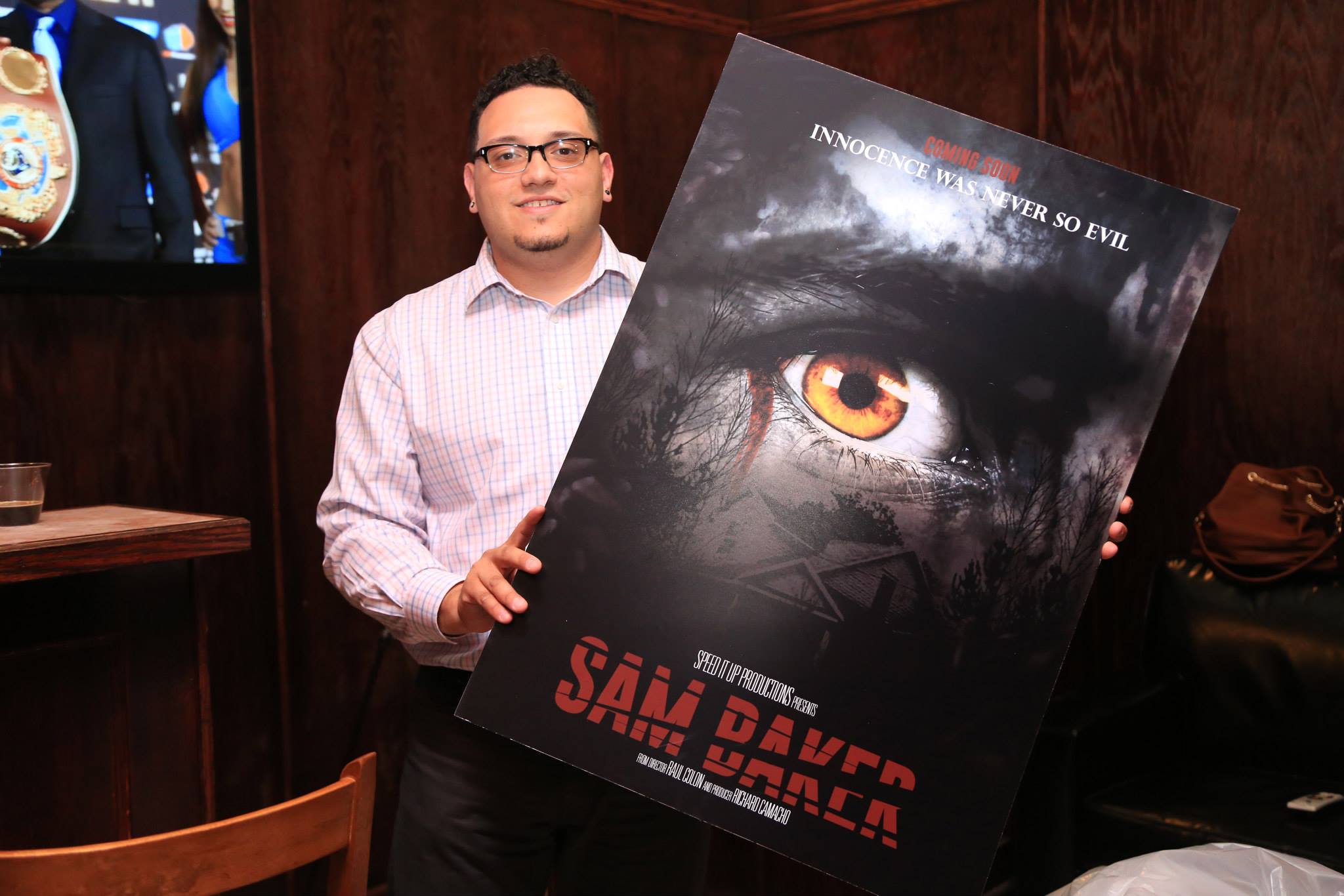 Film Director Raul Colon Holding the poster of 