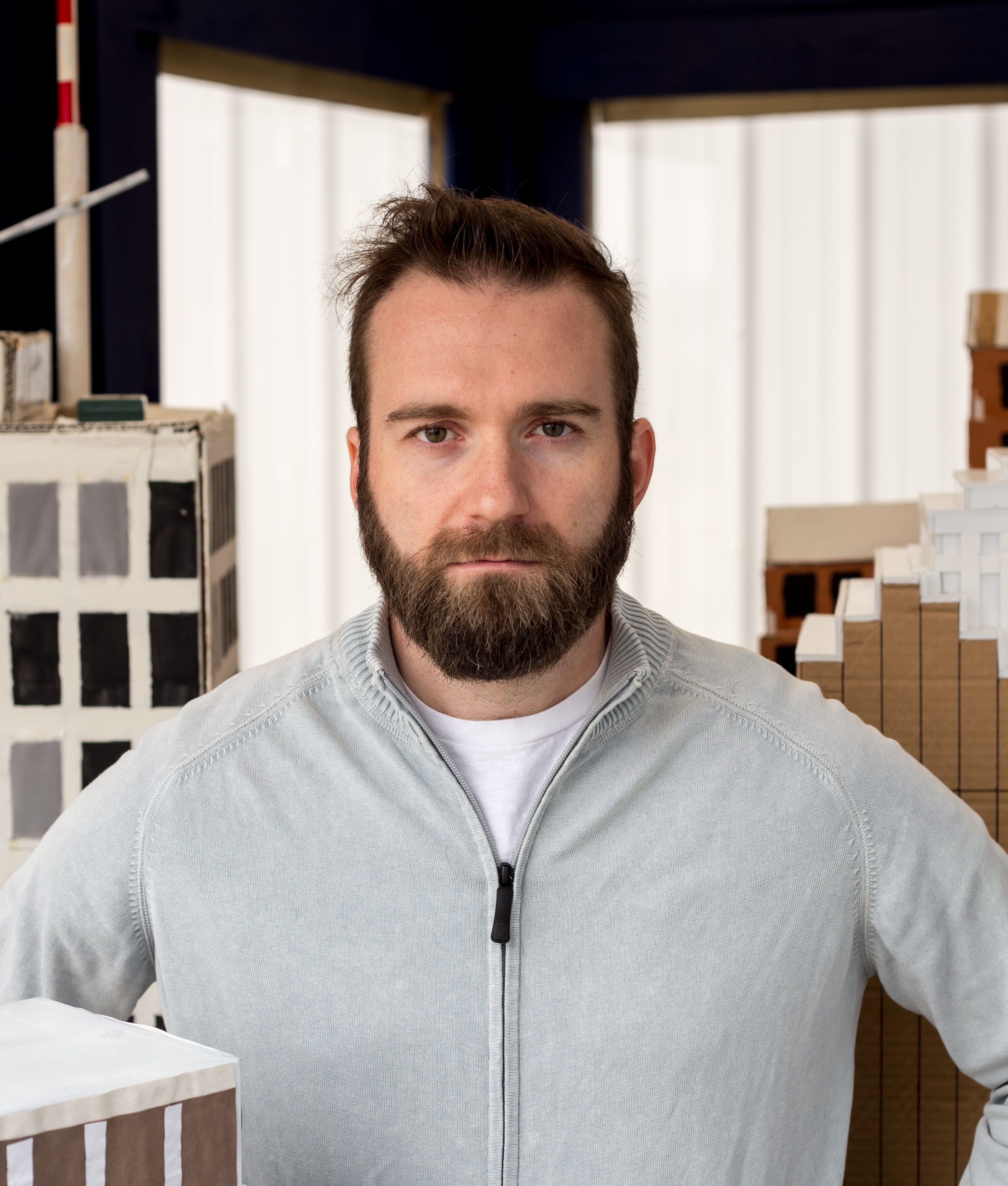 Brandon Ray standing inside his Paper City installation, commissioned by the Houston Arts Alliance.