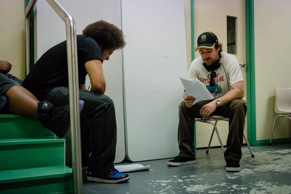 Actor Keyth Williams with Director Josh Hale go through a scene backstage on the set of the film, Seat League.