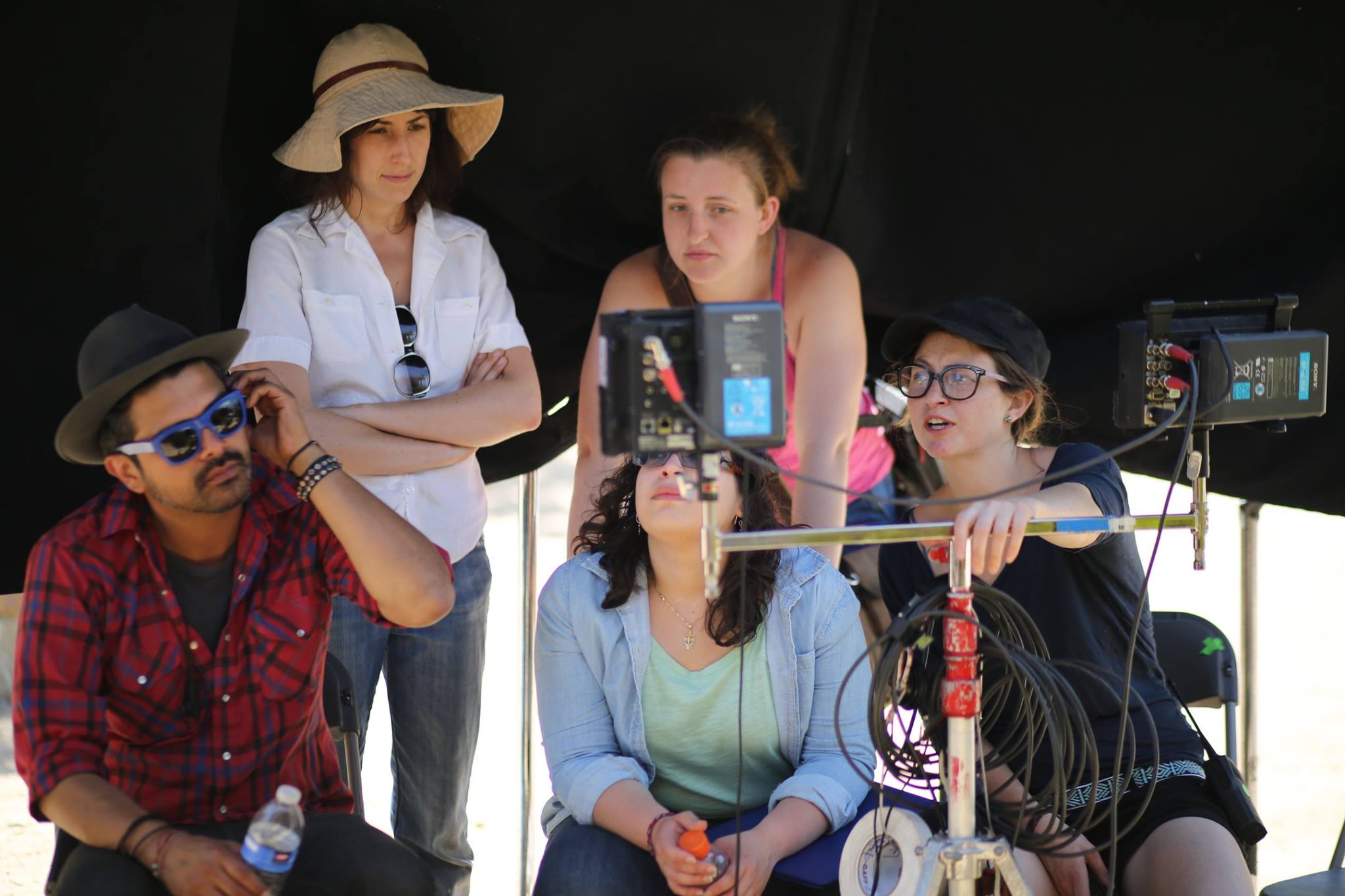 Roe (in pink) as the script supervisor on the set of 