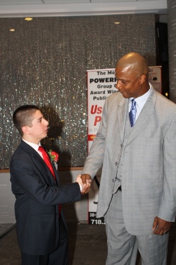 A young Neil A. Carousso (left) is honored with retired Major League Baseball player Darryl Strawberry