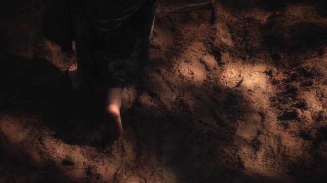 Footsteps through the sand. Screen grab from 