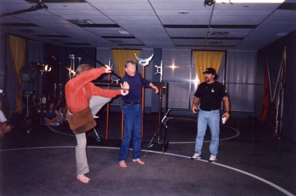 Stunt and fight coordinator Michael Vendrell watches Michael Dawson and Bo Svenson rehearse a fight scene on the 
