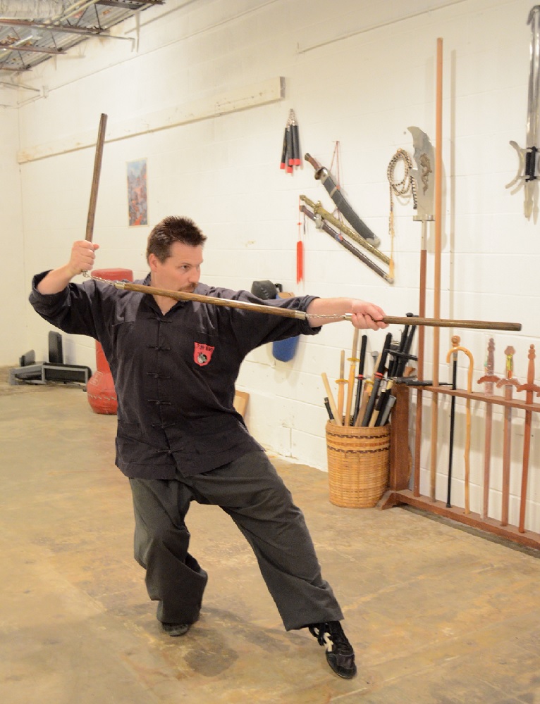 Michael Dawson exhibits a block and thrust ready position with the Three-Sectional Staff (2012).