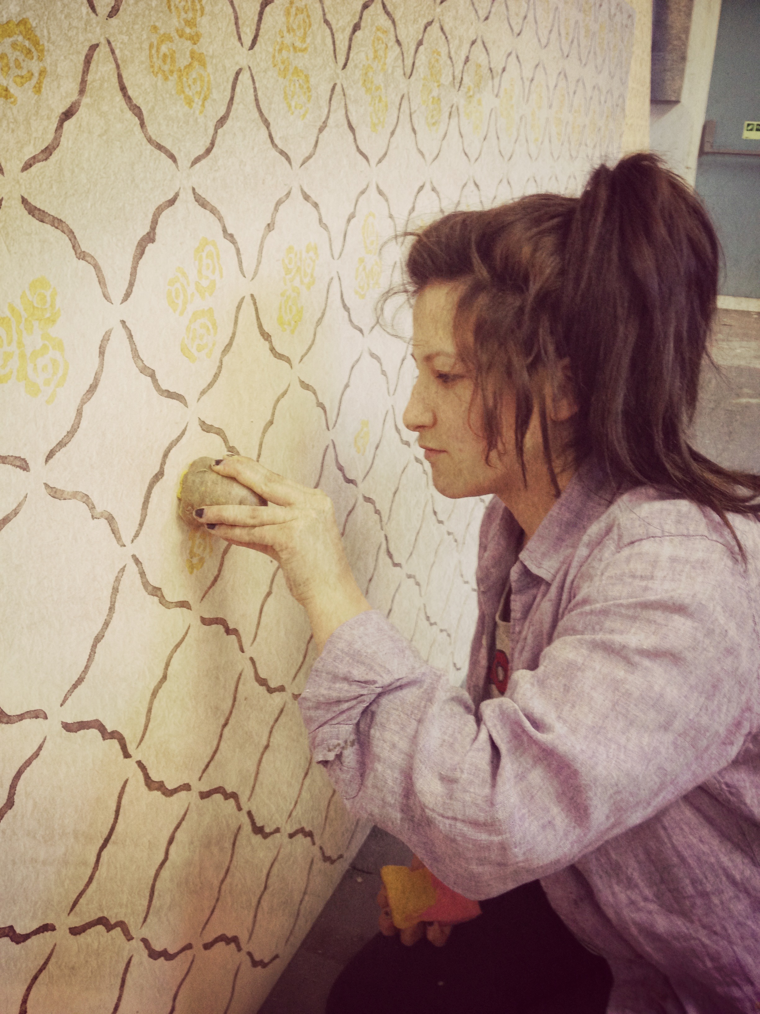 Catherine Bushell, stencilling and potato stamping the walls for 