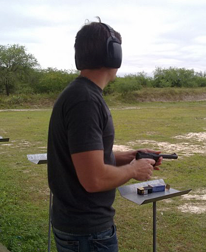 Mike Theiss shooting a gun at the shooting range, one of Mike's hobbies...