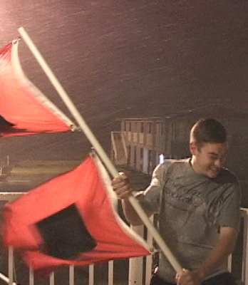 Mike Theiss hanging on to Hurricane Flags in a Hurricane in Florida.