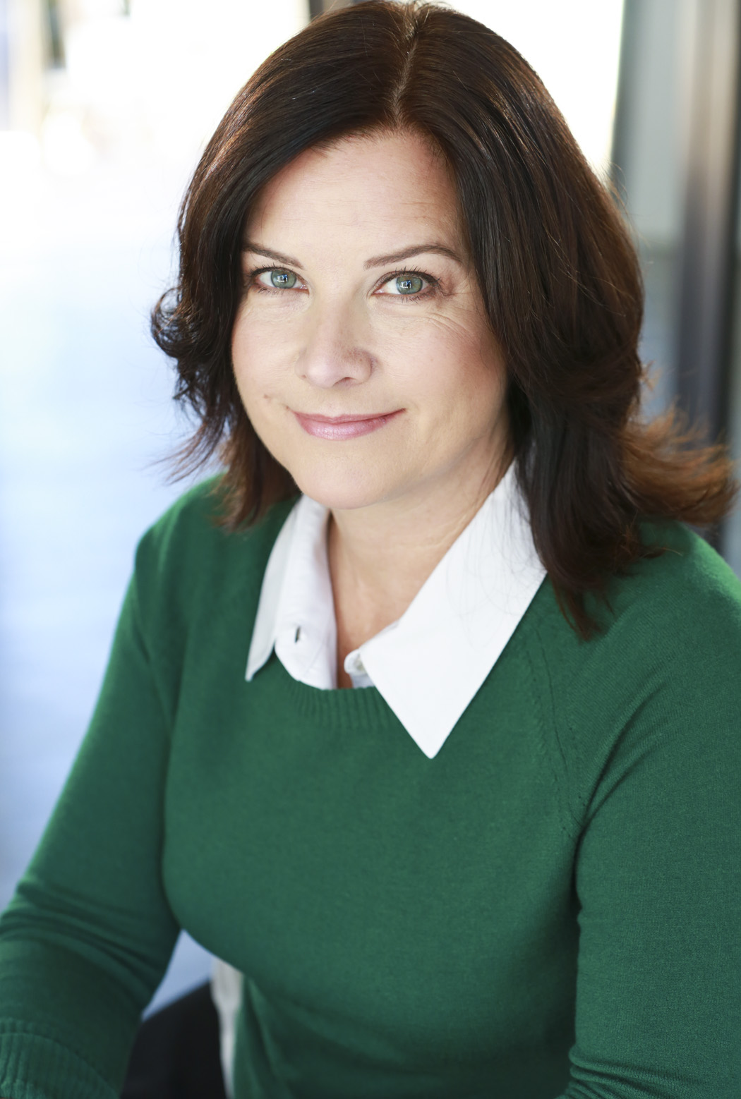 Camille James Harman Commercial Headshot Green Sweater