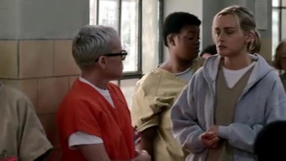 IN THE BACK ROUND ORANGE IS THE NEW BLACK