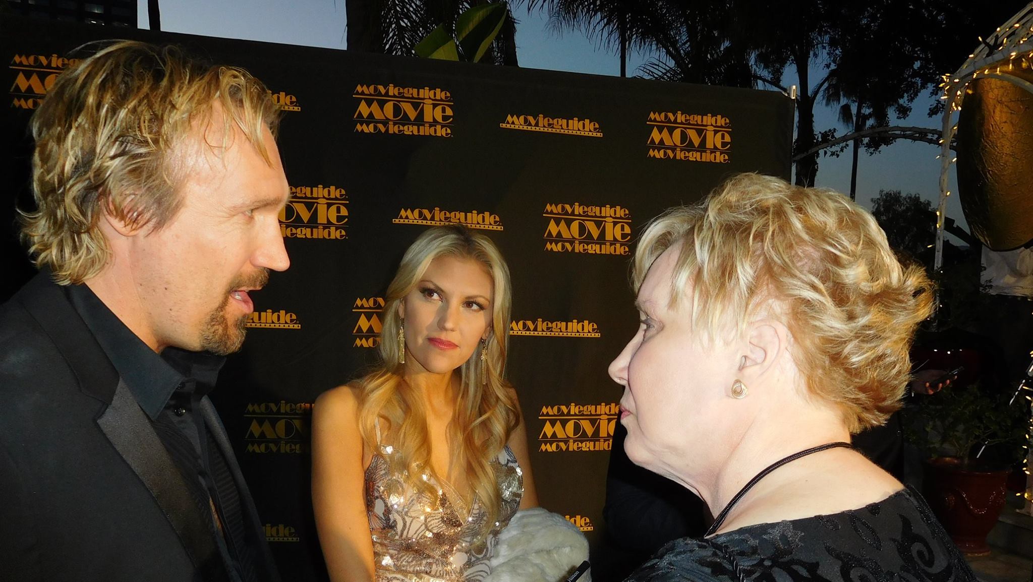 Interviewing David R. White (Pure Flix CEO and actor) and wife Andrea Logan on red carpet at Movieguide 24th Annual Awards Gala, 2016, as interviewer and journalist