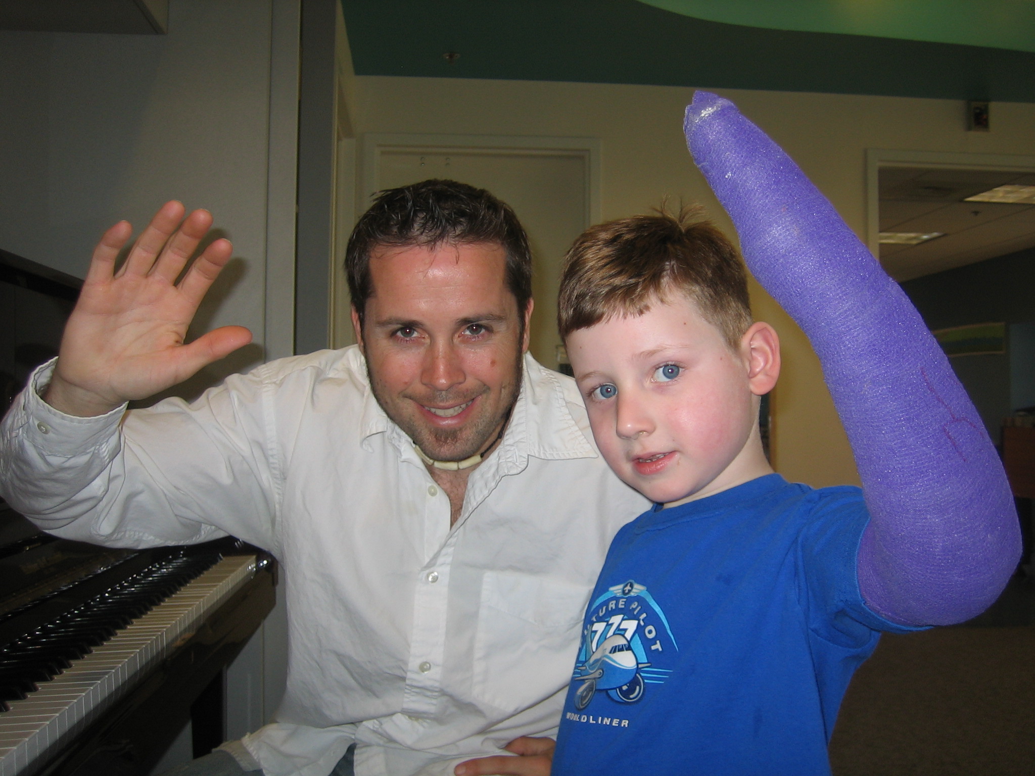 Mateo Messina playing piano with a patient at Seattle Children's Hospital.