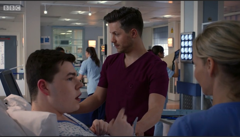 Max J Green as Stephen Holting in a scene with Kaye Wraggs as Essie and David Ames as Dom in Holby City. Episode Title Return to Innocence S17 Ep 42 All time Episode Number 777