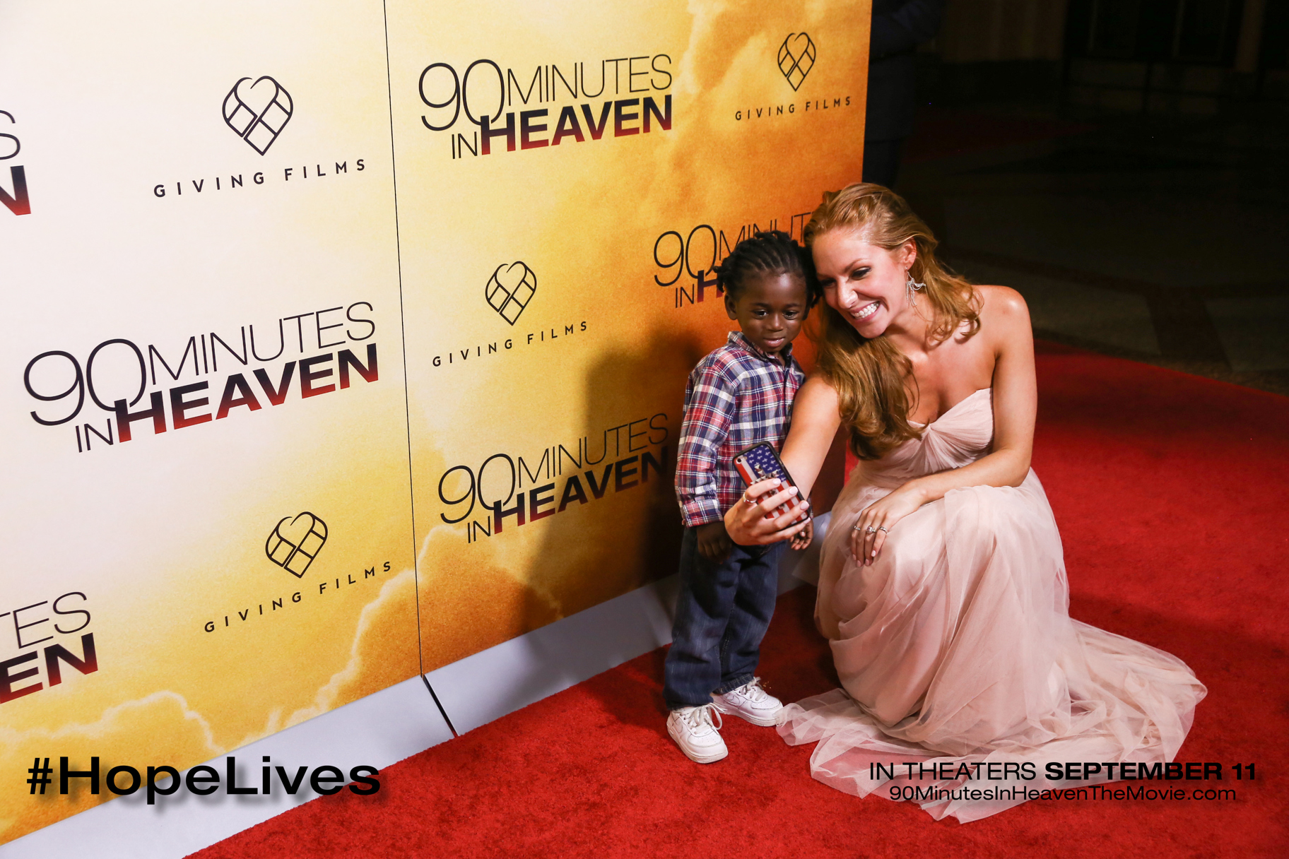 Rachel Jeanette on the red carpet with a child at the 90 Minutes in Heaven Premier