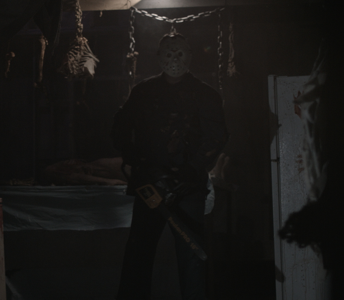 Having fun playing the role of Jason with chainsaw at a haunted attraction