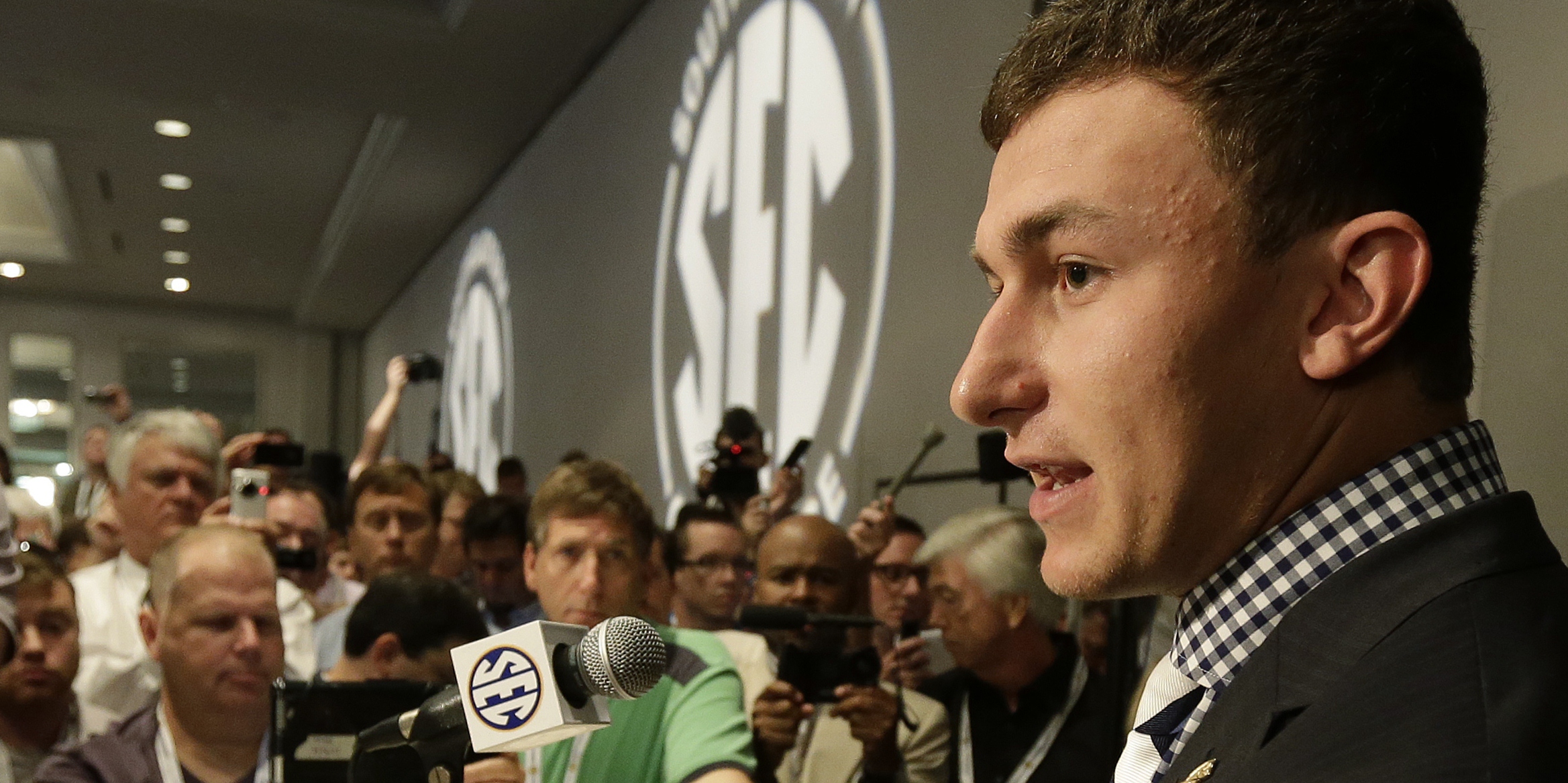 Johnny Manziel answering questions at the 2013 SEC Media Days in Birmingham. Duane Rankin was among the media present filming Manziel