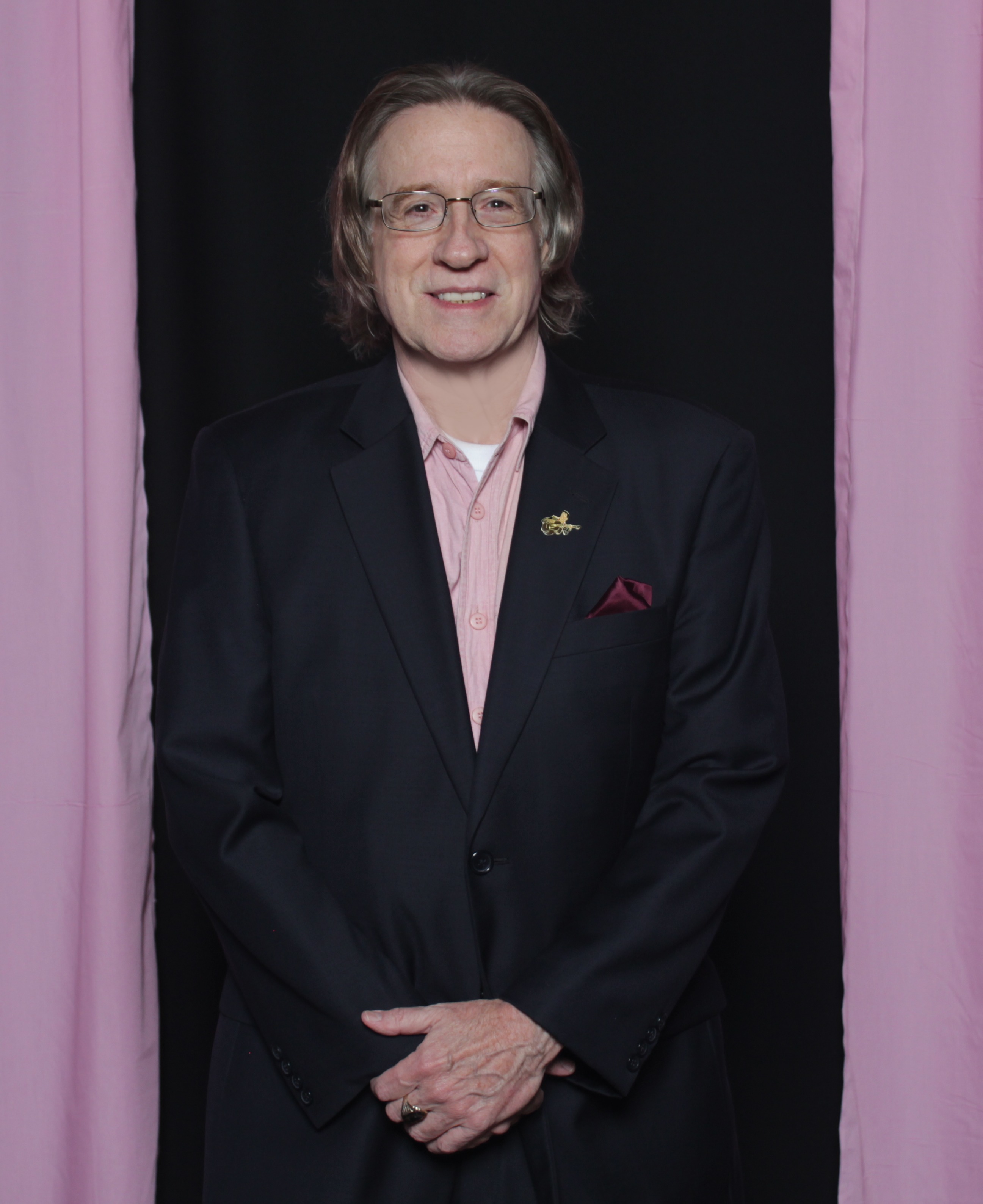 Pink shirt and Elvis lapel pin, during 'Celebrity Bartenders for Moms on the Run' fundraiser to fight breast cancer October 24, 2015.