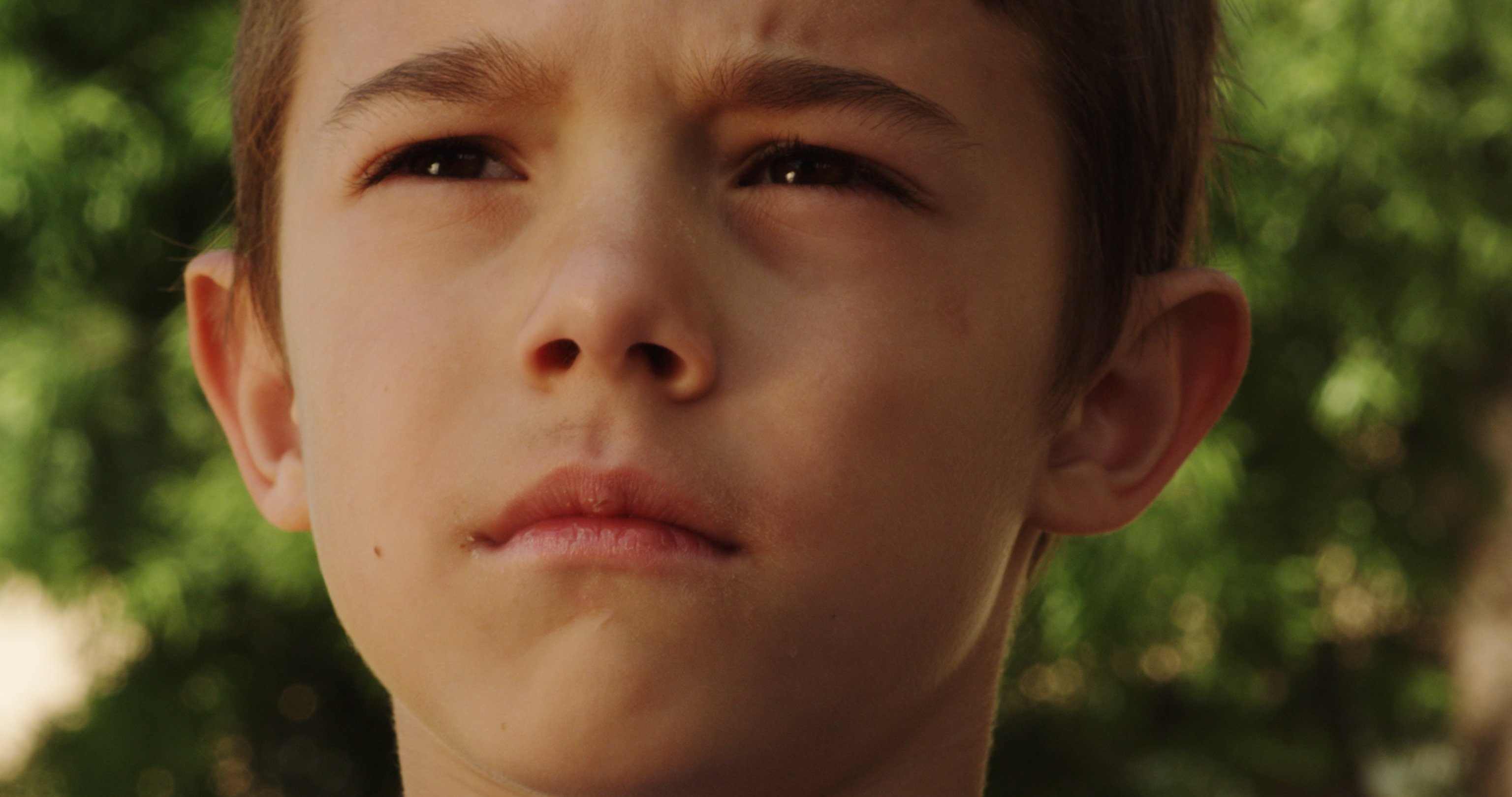 Joey (Kobe Humphries) stands afraid, yet brave, at the playground high noon standoff with bully Jules.