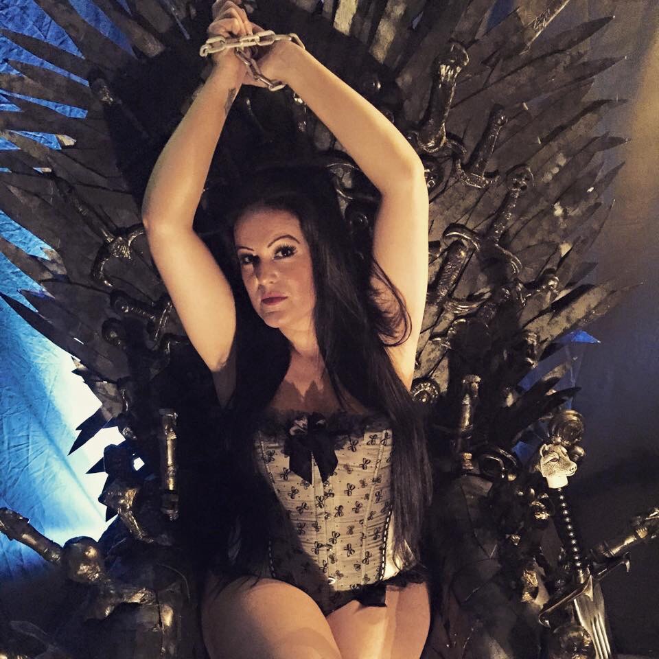 Victoria during a photo shoot on a replica Iron Throne from Game of Thrones