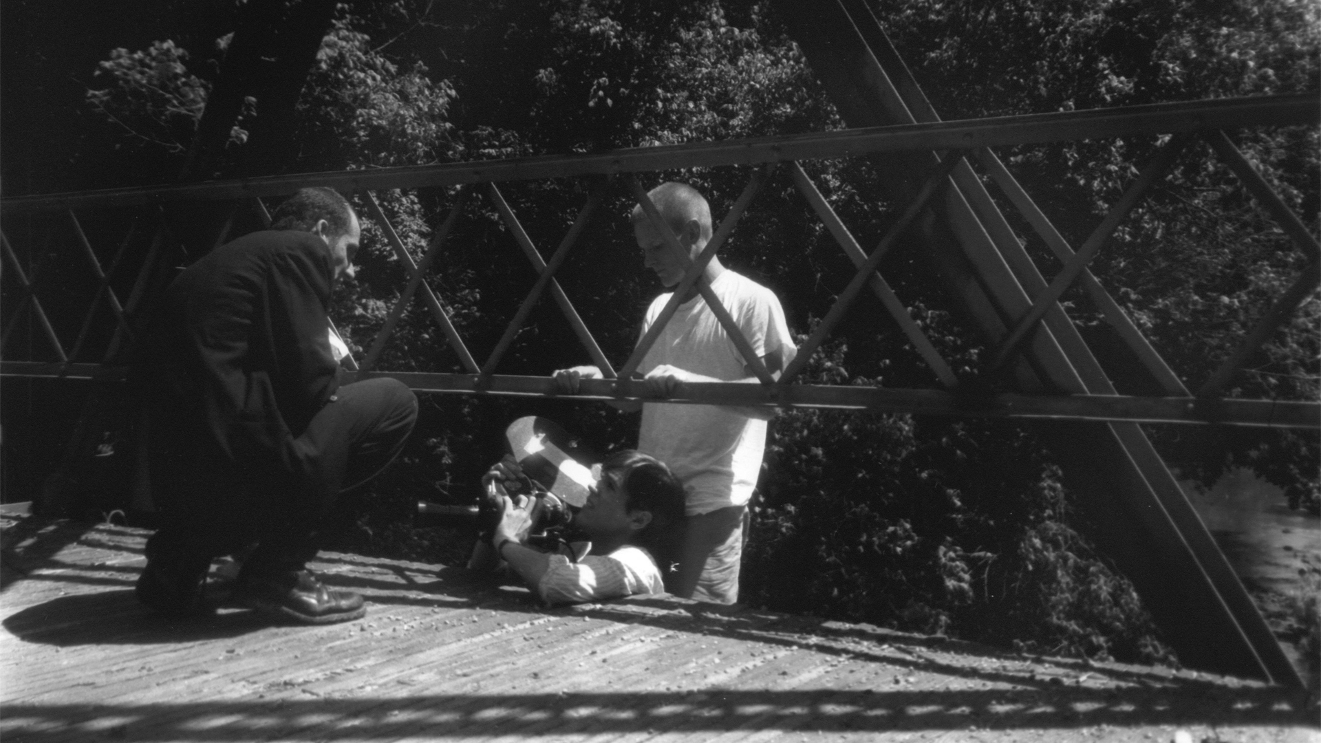 B.D.Kuchera and Michael J.Taylor hang from a bridge to get a shot