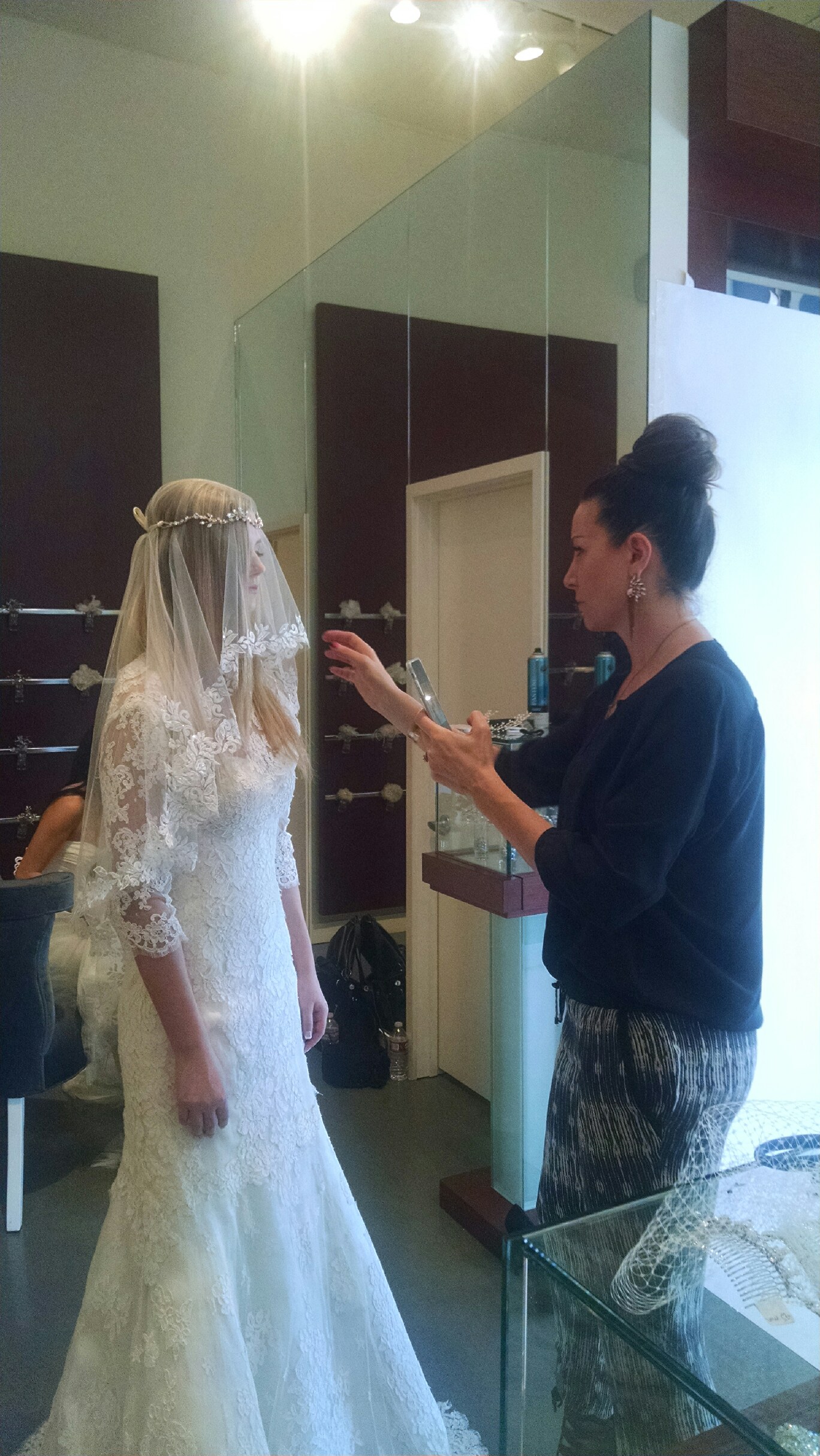Amy going through final photo shoot prep by designer/owner Erin Cole of Erin Cole Couture Bridal.