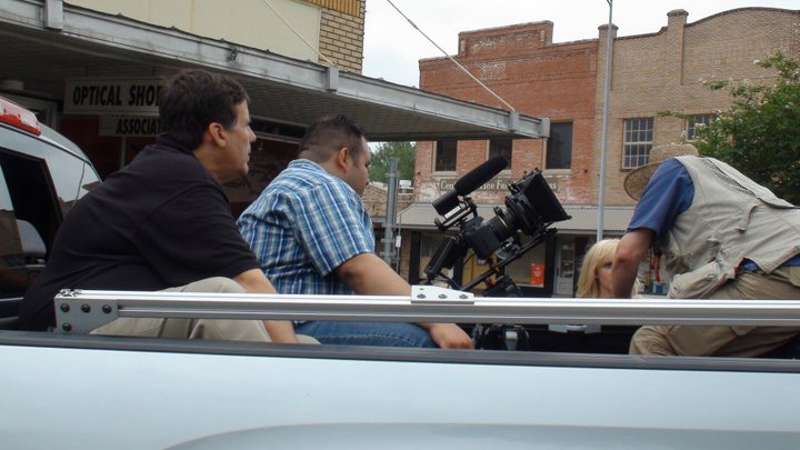 Michael Walters and Carlos Tovar preparing to go shoot B-roll from the back of the truck, in 