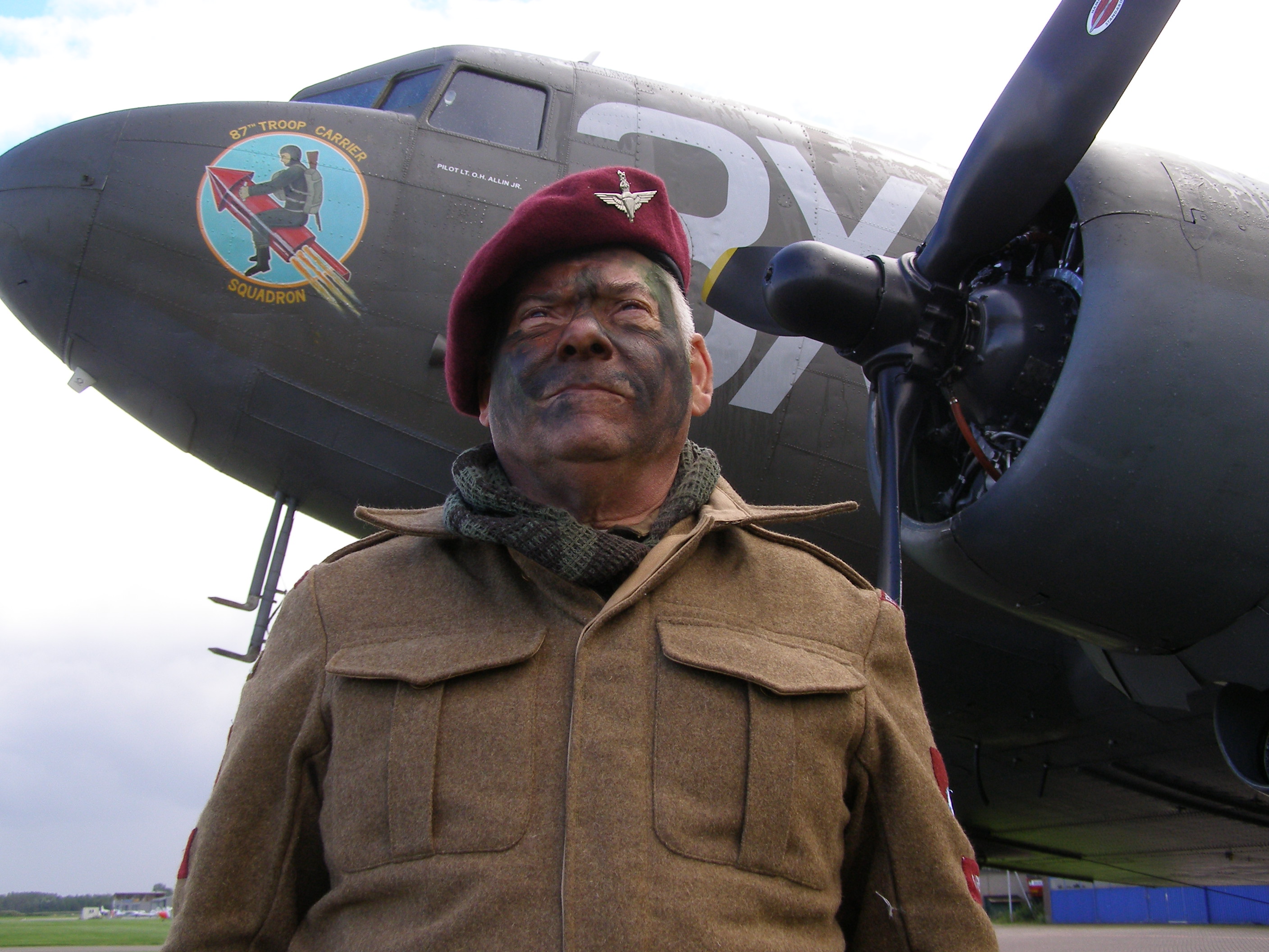 Author one hour after his Operation Market Garden commemoration parachute jump September 17, 2010 on the Arnhem Battlefield, Netherlands. Our C-47, background, had 60 WW2 German bullet holes along the right side, all patched.