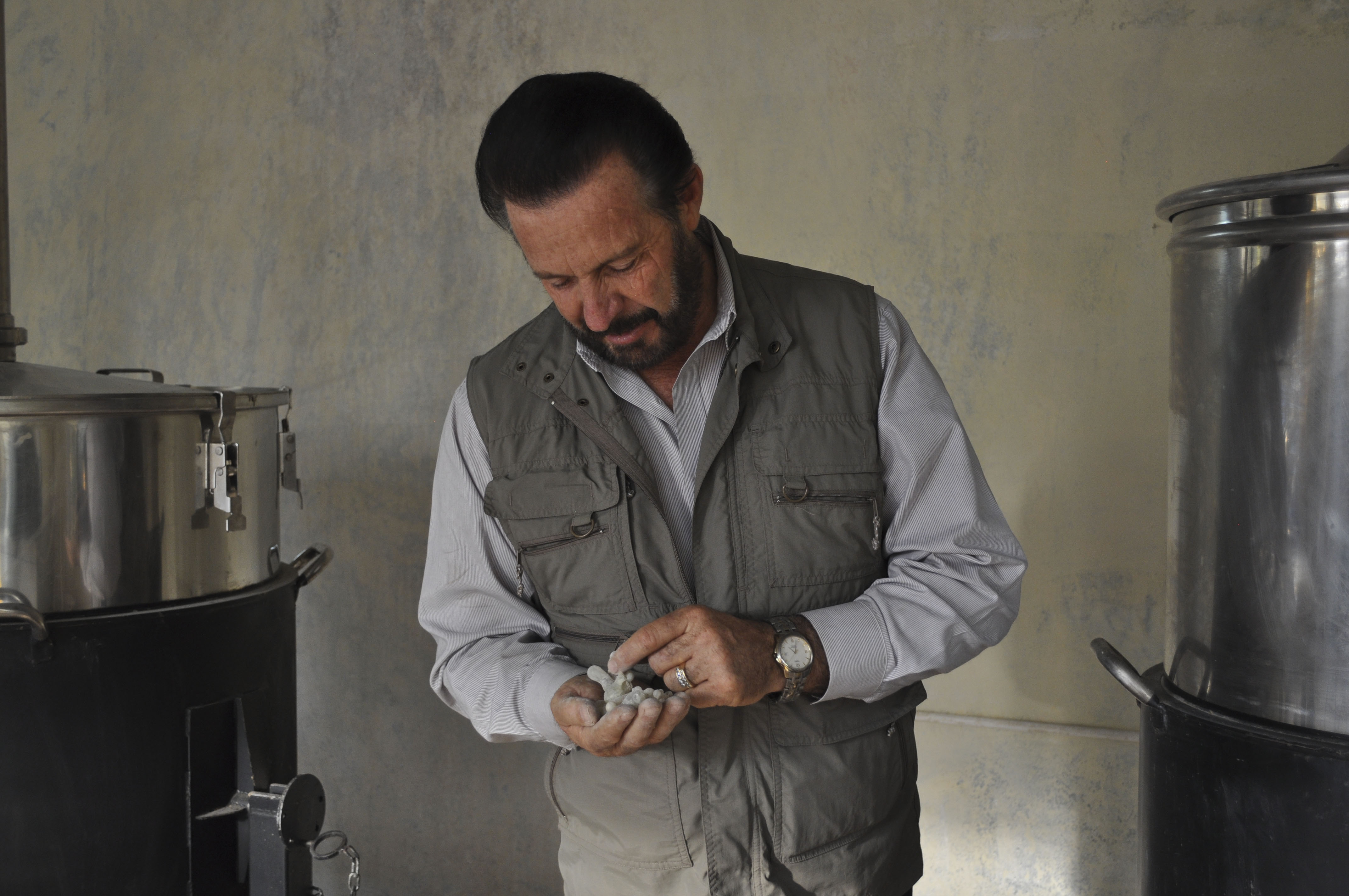 Gary Young inspects the essential oil distilling process