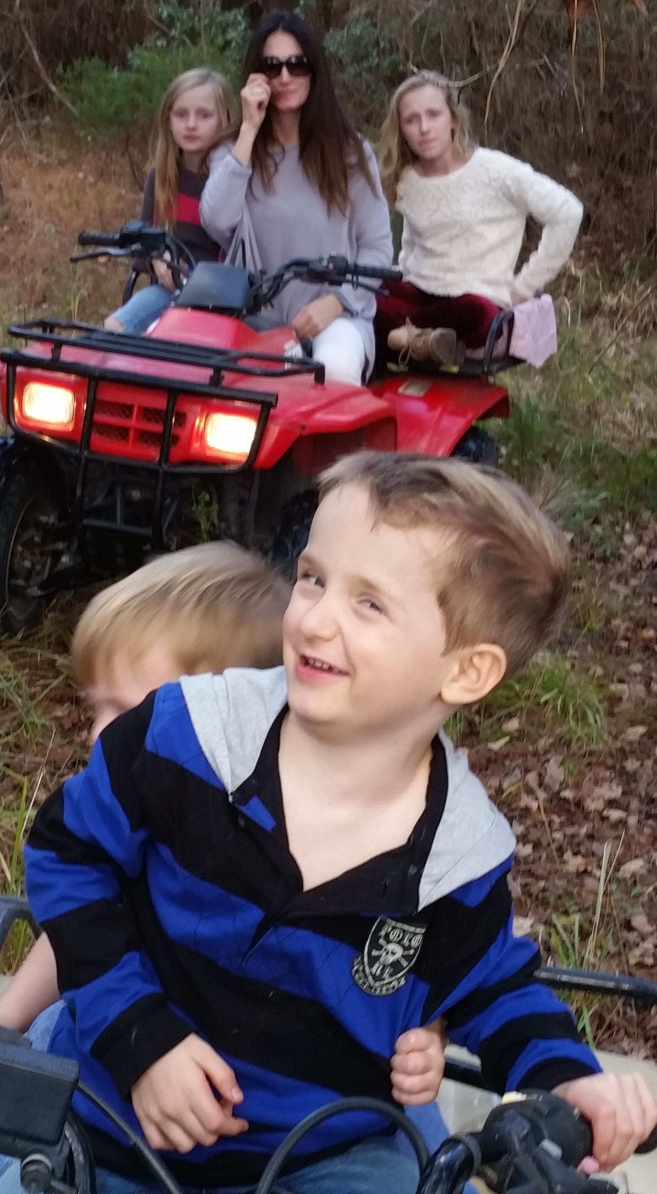 Landon driving a four wheeler at Papa's house during Thanksgiving.