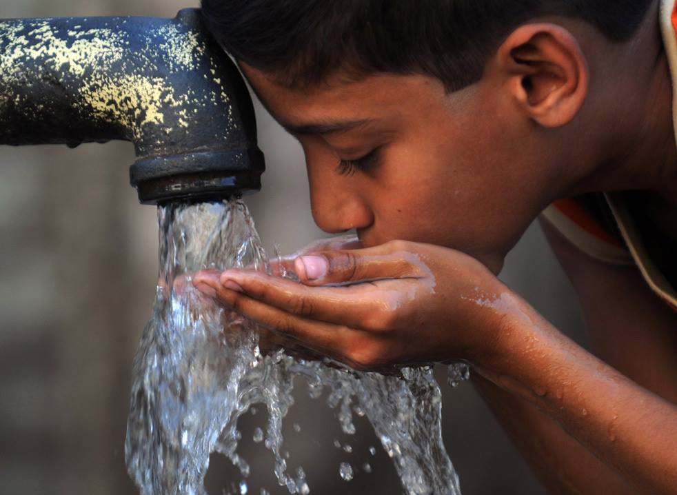 Boy (of third world country) drinks water