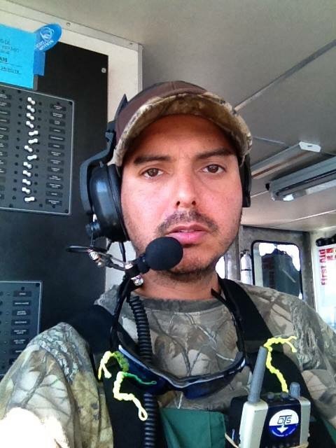 Diver in the water running topside operations on Bering Sea. Two man crew running gold dredge. Rotating shifts.