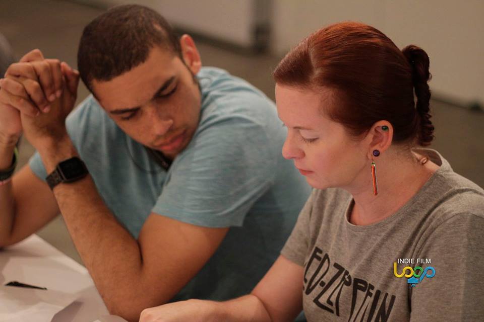 Dewon Baker discussing with Assistant Director Leah Michelle Long.