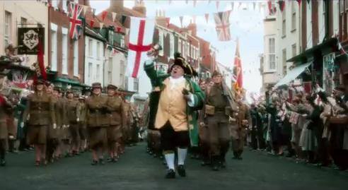 David Hinde As 'Walmington On Sea Town Crier' Leading The St Georges Day Parade In Dads Army Movie 2016 Universal Pictures.Filmed In Bridlington Old Town,East Yorkshire.England UK