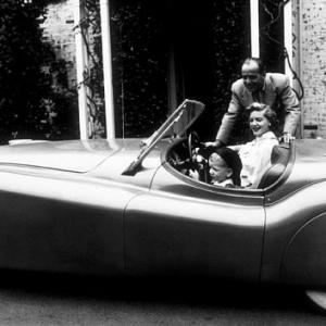 Humphrey Bogart Lauren Bacall and their son Stephen in his Jaguar XK120 at home in Los Angeles CA 1952