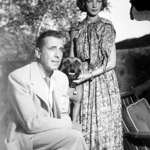 Humphrey Bogart and Lauren Bacall with their pet boxer, circa 1949.
