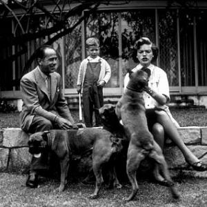 Humphrey Bogart, Lauren Bacall, and their son, Stephen, with their pet boxers at home in Los Angeles, CA, 1952.