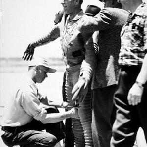 Humphrey Bogart with crew helping him into pilot suit for Chain Lightning 1950 Warner Bros