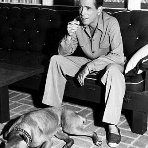 With his pet boxer at home circa 1949