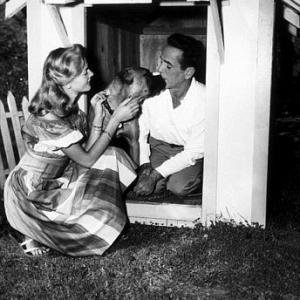 Humphrey Bogart and Lauren Bacall with their pet boxer Harvey at their Benedict Canyon home CA 1948