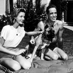 Humphrey Bogart and Lauren Bacall with their pet boxer at their Benedict Canyon home CA 1947