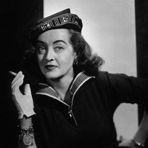 Bette Davis holding a cigarette, circa 1954. Vintage silver gelatin, 16.25x13.25, flushmounted, gold-toned, embossed. $1100 © 1978 Wallace Seawell MPTV