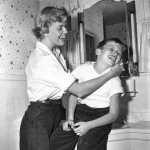 Doris Day Washing behind son Terry's ears 1950