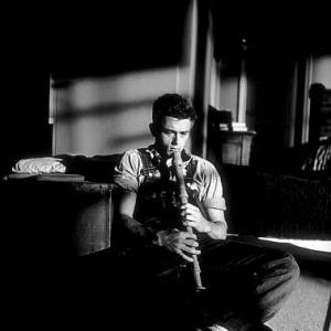 James Dean plays a baritone recorder given to him by a fan while on location for 