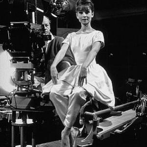 573463 Paris When It Sizzles Audrey Hepburn poses for a fashion layout while director R Quine looks on