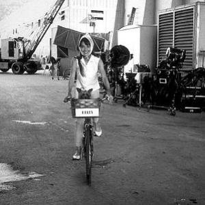 332330 Audrey Hepburn rides to the makeup department on the Warner Brothers lot during the filming of My Fair Lady