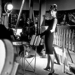 332328 Audrey Hepburn part of a fashion layout photographed on the set of Paris When It Sizzles